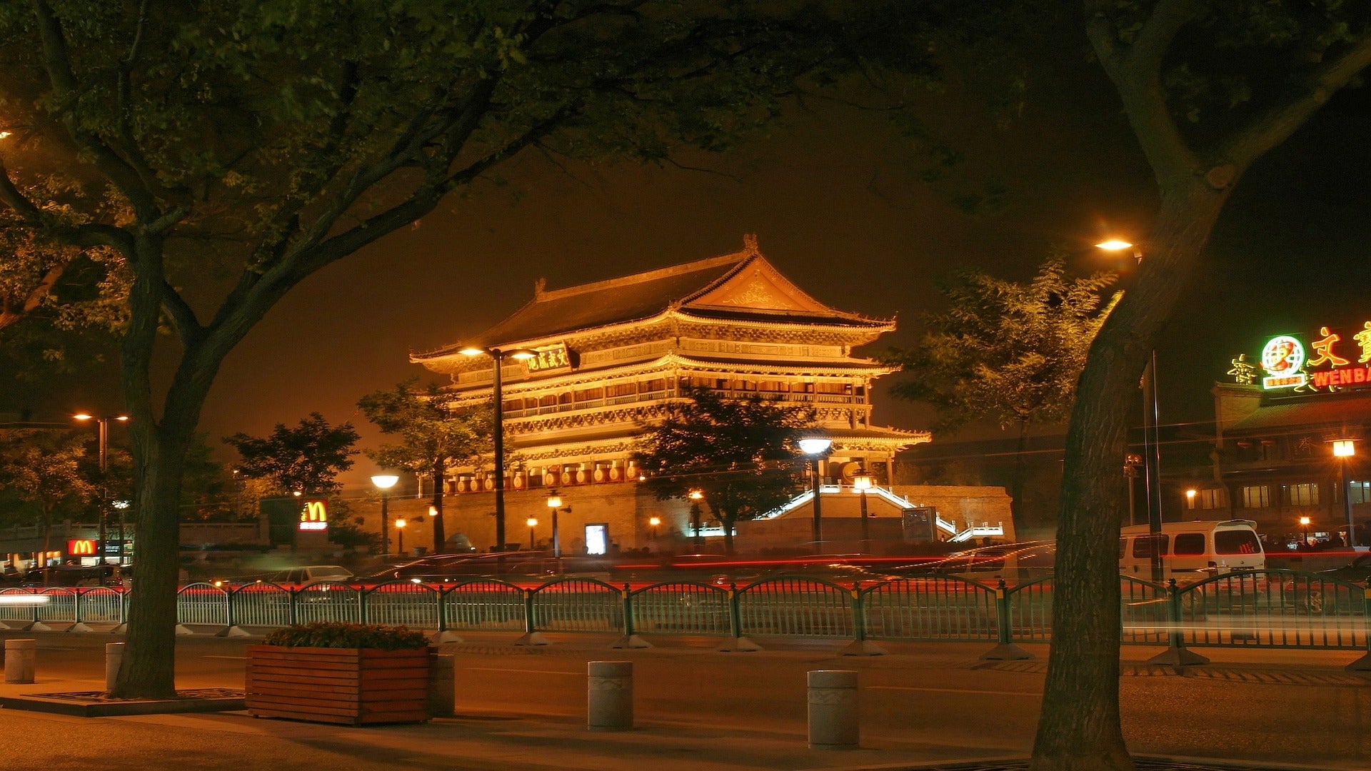 an old chinese building on a night with shining lights as travel target for esim
