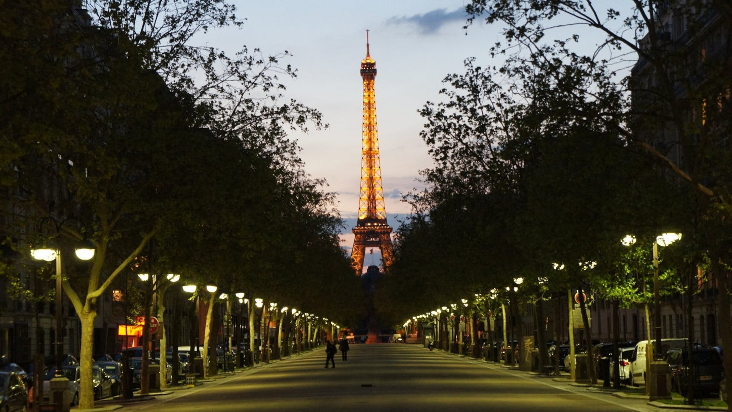 Eiffel tower at night with a beautiful road as travel target for eSim